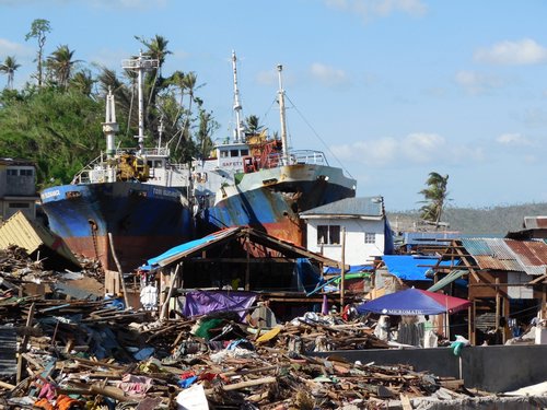 Ships pushed ashore with debris from homes and businesses during the storm surge from Typhoon Yolanda 